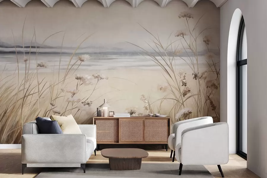 Fotobehang Een tarweveld met witte bloemen op de voorgrond, een strand en de oceaan op de achtergrond, neutrale pastel gedempte kleuren w09298