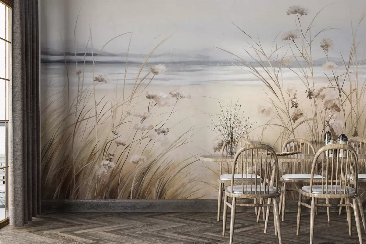 Fotobehang Een tarweveld met witte bloemen op de voorgrond, een strand en de oceaan op de achtergrond, neutrale pastel gedempte kleuren w09298